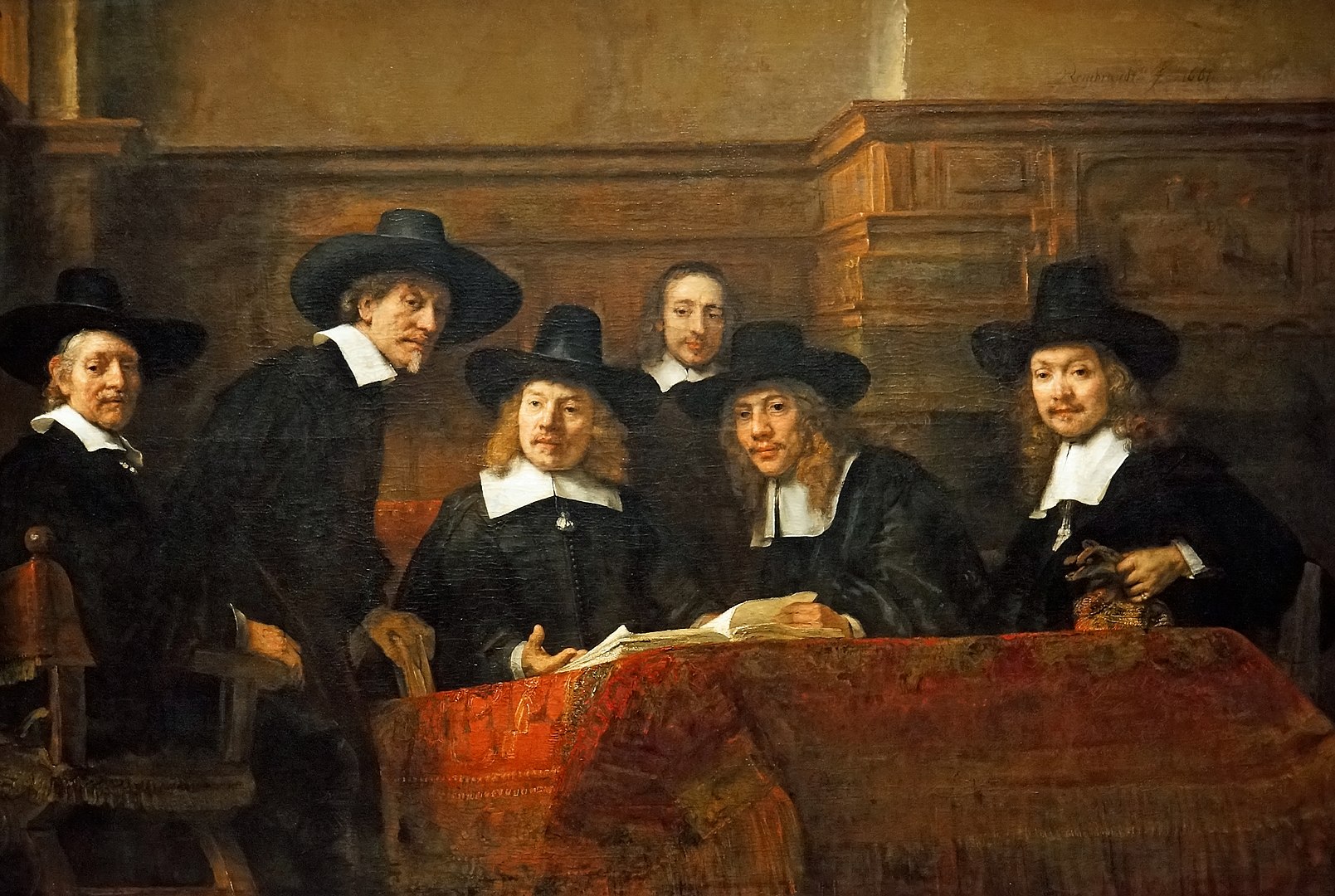 Oil painting showing six men wearing black attire and wide-brimmed hats sit around a table covered with an ornate red cloth, engaged in conversation. *The Syndics of the Drapers' Guild* (1662) by Rembrandt via [Wikimedia](https://en.wikipedia.org/wiki/Rembrandt#/media/File:Netherlands-4183_-_The_Syndics,_Rembrandt.jpg)